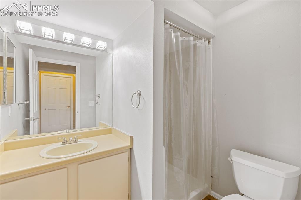 Image 18 of 33: Bathroom with vanity and a shower with shower curtain