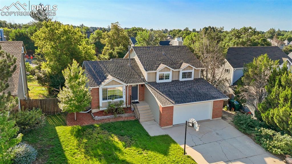 Image 2 of 33: View of front of home featuring brick siding, board and batten siding, conc