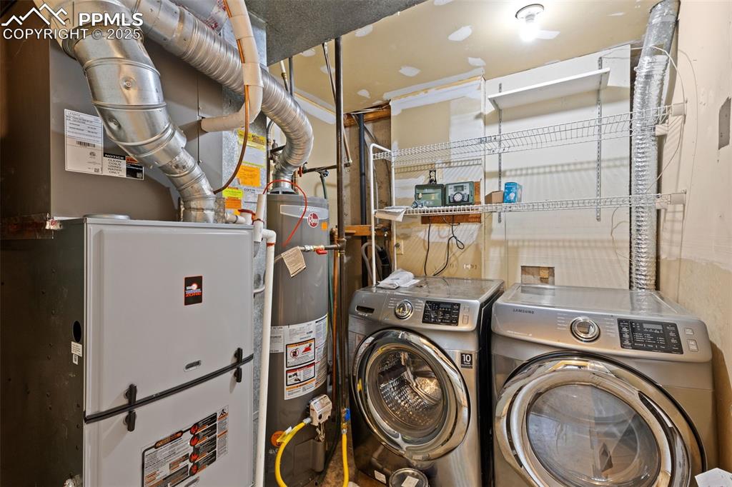 Image 22 of 33: Laundry area with washer hookup, heating unit, and gas water heater