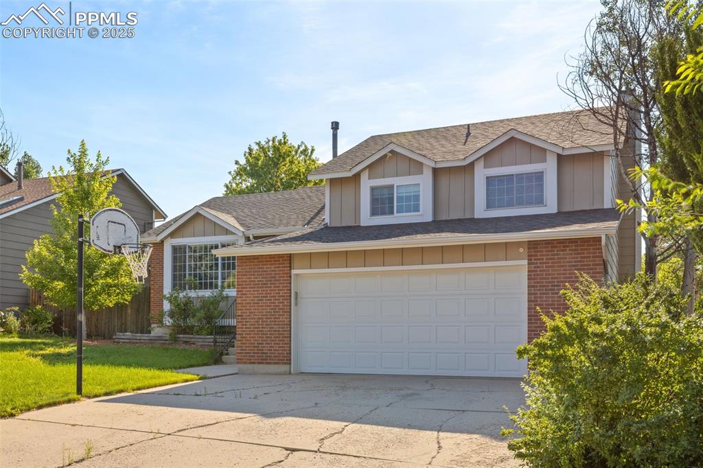 Image 31 of 33: View of front facade featuring board and batten siding, roof with shingles,