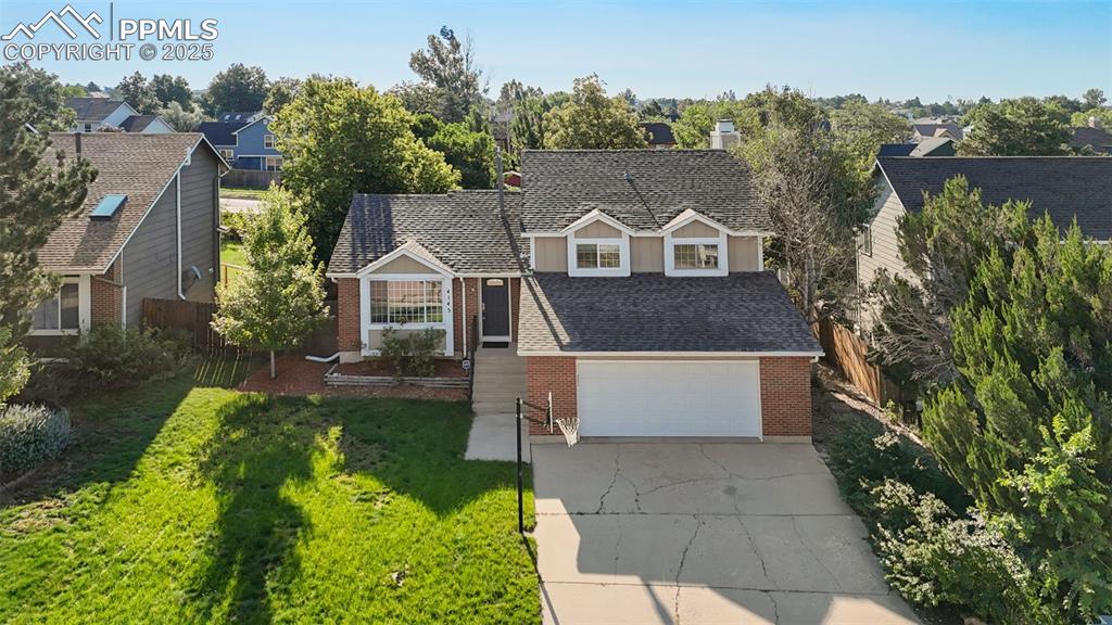 Image 32 of 33: View of front of property featuring brick siding, driveway, a garage, and r