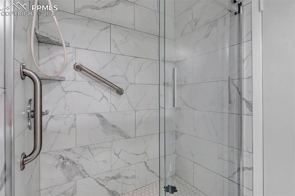 Image 17 of 37: Bathroom featuring a shower stall
