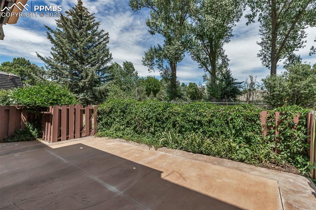 Image 36 of 37: Fenced backyard with a patio area
