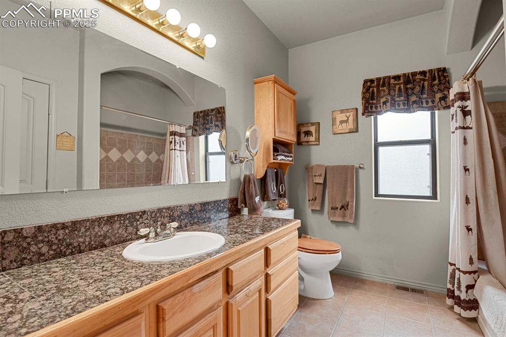 Image 18 of 43: Full bath with vanity and tile patterned flooring