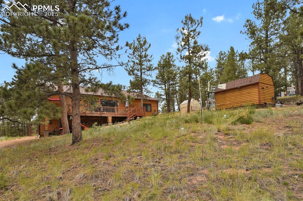 Image 32 of 43: View of yard featuring a deck and an outdoor structure