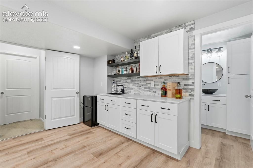 Image 13 of 28: wet bar in basement 