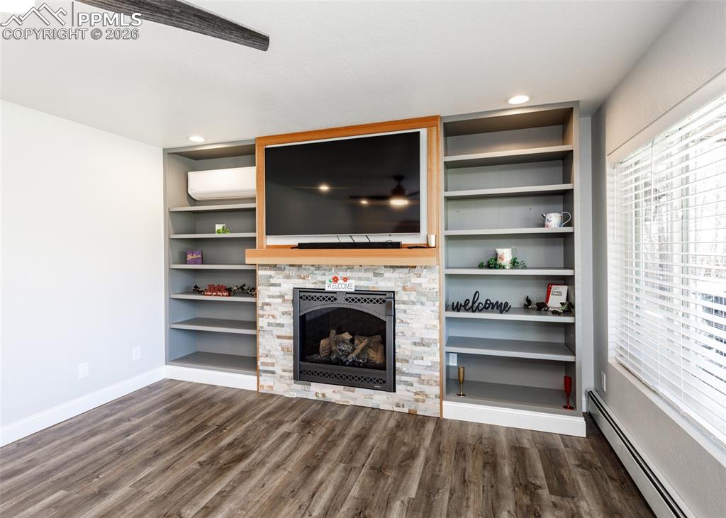 Image 9 of 39: Living room with gas log fire place