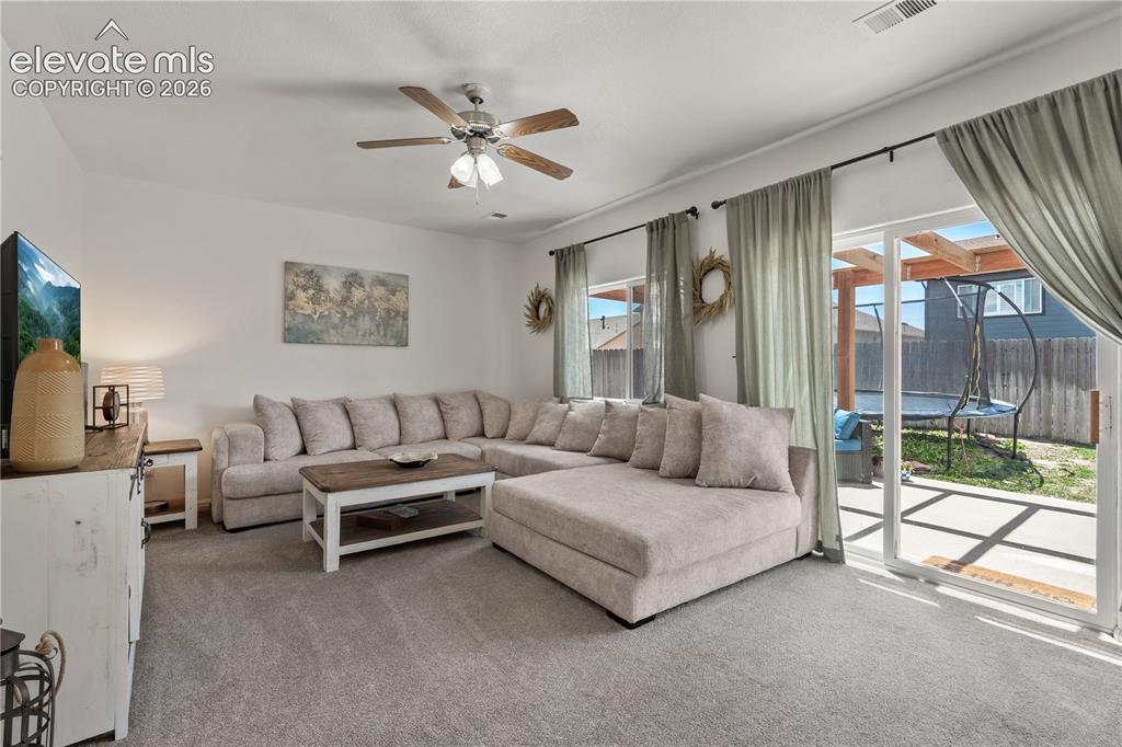 Image 16 of 41: Open-concept dining area with wood-finish flooring and a vaulted ceiling