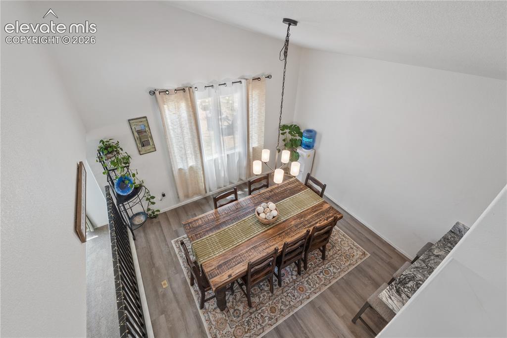 Image 21 of 41: Two-story entryway with a vaulted ceiling, framed by a single-pane window a