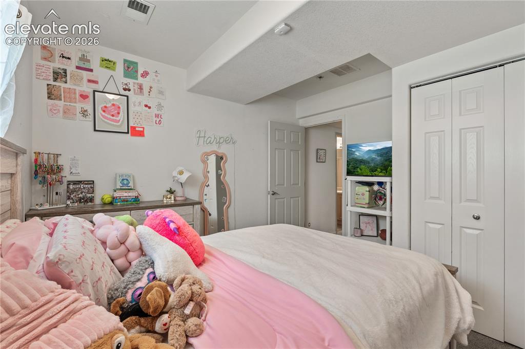 Image 36 of 41: Bright interior space with light-toned walls and neutral carpeting