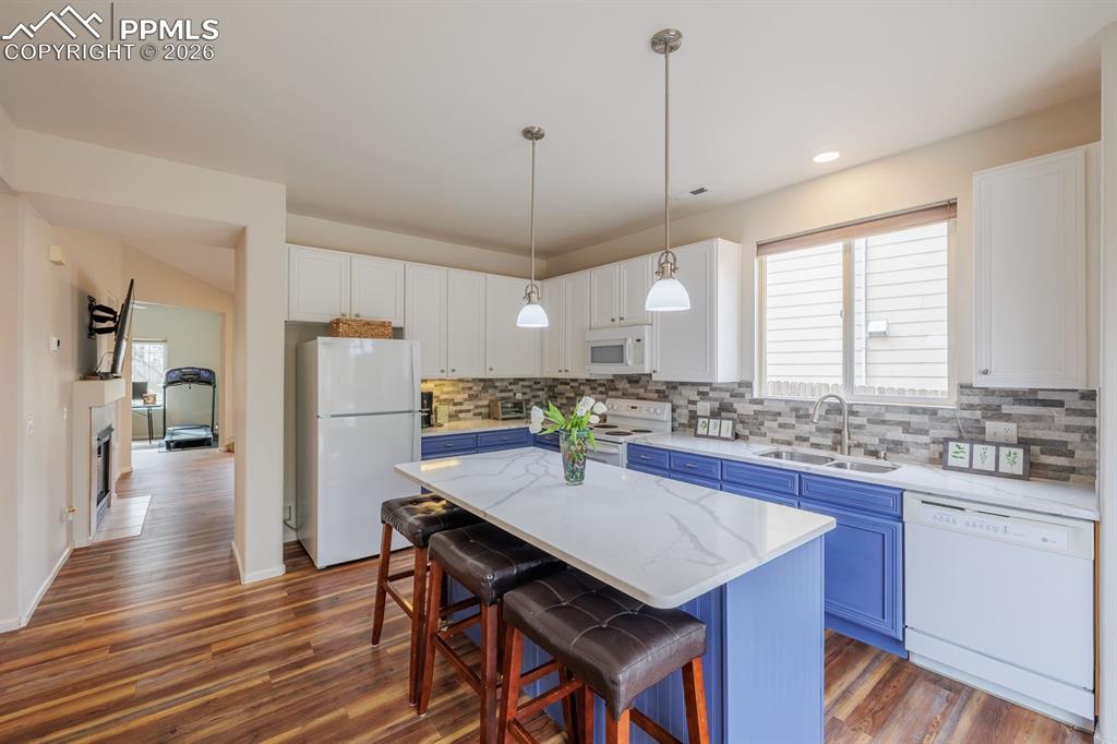 Image 11 of 36: Fantastic upgraded kitchen with quartz island, countertops and custom tile 