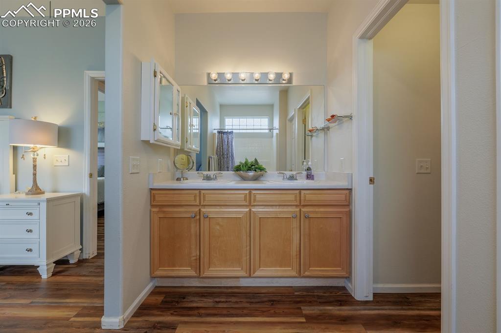 Image 19 of 36: Light and bright primary bathroom with a jetted tub and block glass letting