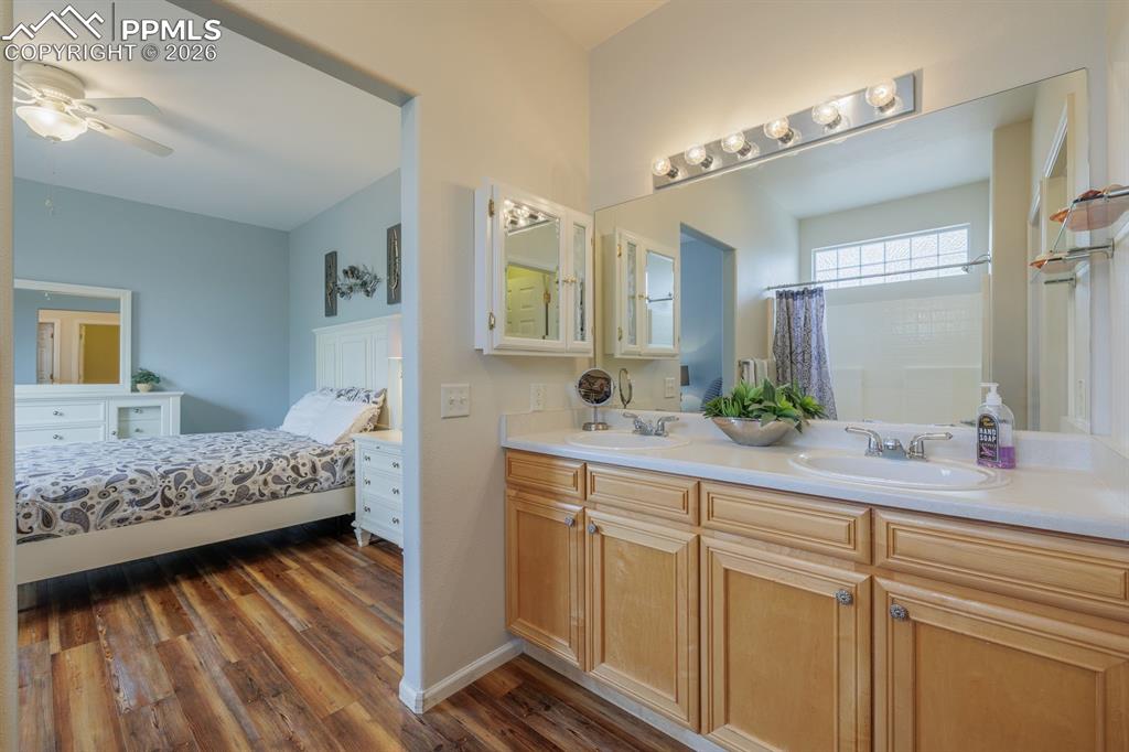 Image 20 of 36: Walk in closet incorporated inot the primary bathroom with separate water c