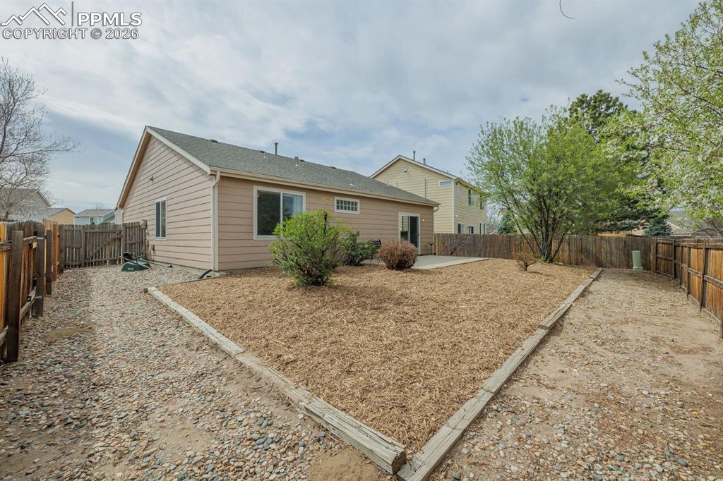 Image 27 of 36: Could add a dog run on the side of the home in this nice sized yard