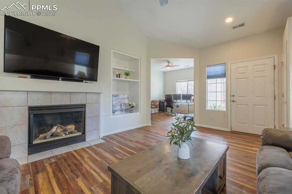 Image 8 of 36: Gas fireplace with mantel and  bookshelves