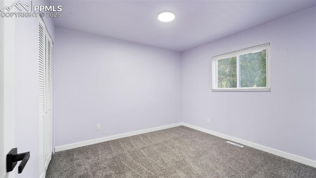 Image 16 of 28: Unfurnished bedroom with carpet flooring and a closet