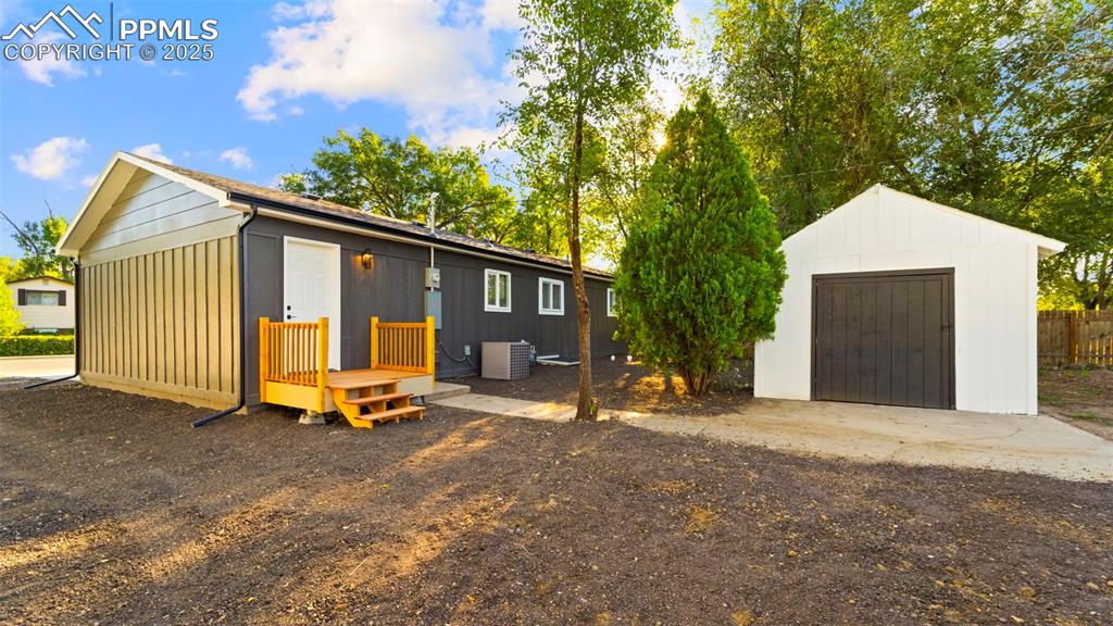 Image 18 of 28: View of front facade featuring an outbuilding and board and batten siding
