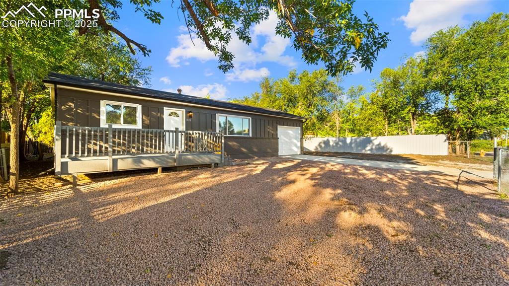 Image 2 of 28: View of front of property featuring a wooden deck, board and batten siding,