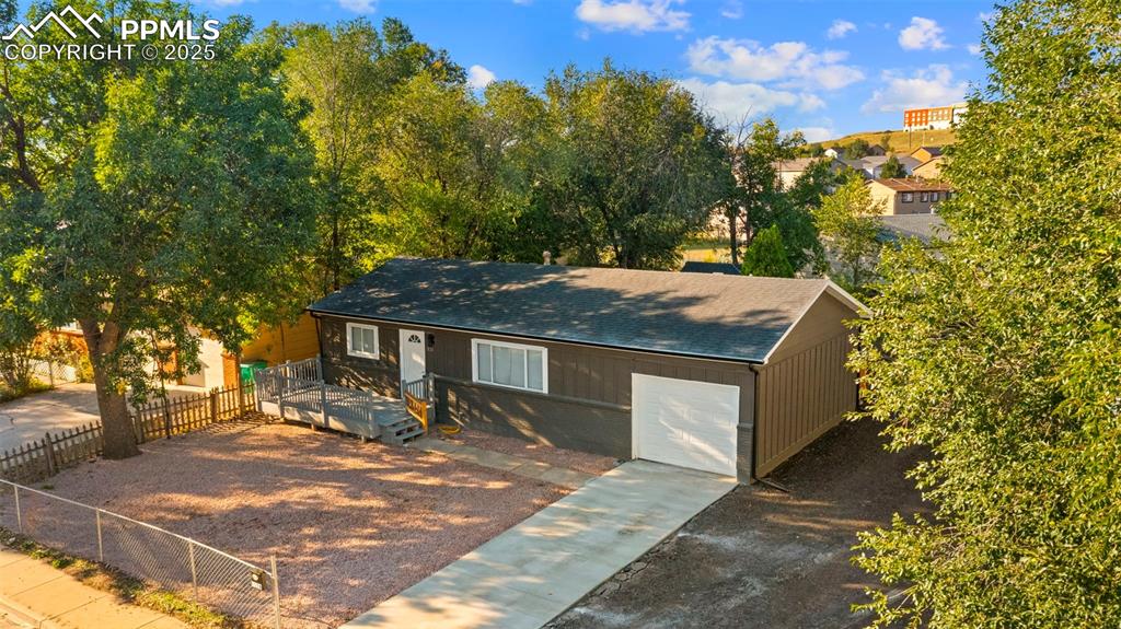Image 22 of 28: View of front facade with roof with shingles and a garage