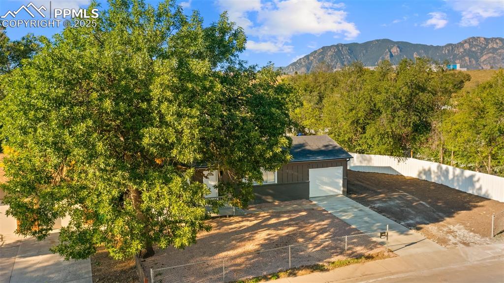 Image 24 of 28: View from above of property with mountains