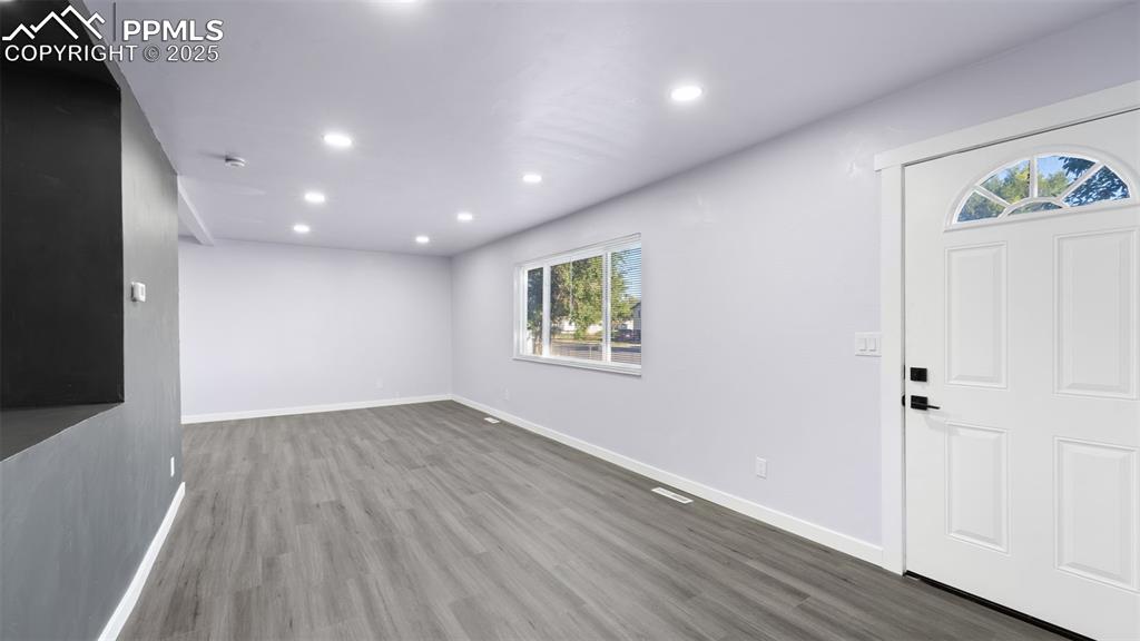 Image 6 of 28: Foyer with wood finished floors and recessed lighting