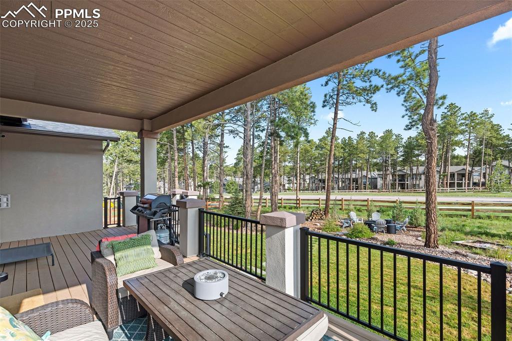 Image 40 of 40: Wooden terrace featuring outdoor dining area