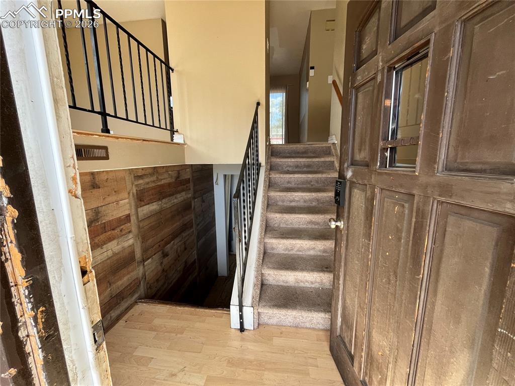 Image 3 of 13: Stairs featuring wood finished floors