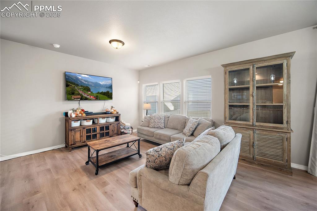 Image 6 of 36: Spacious and bringt living room open to the kitchen and dining space.
