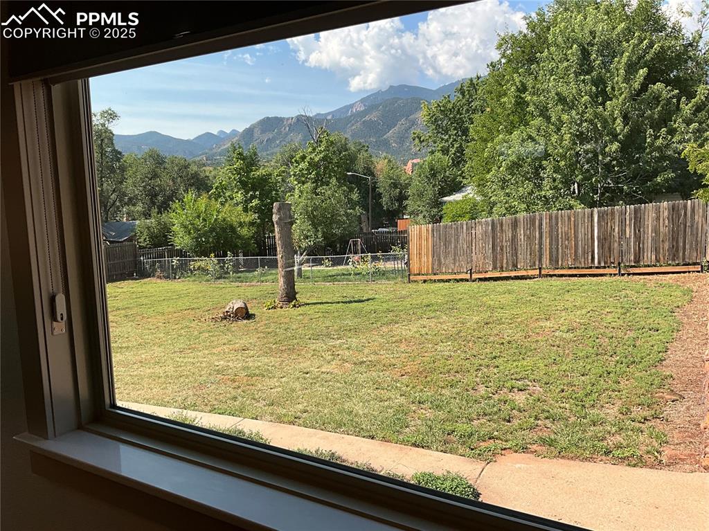 Image 16 of 50: Fenced backyard featuring mountain views