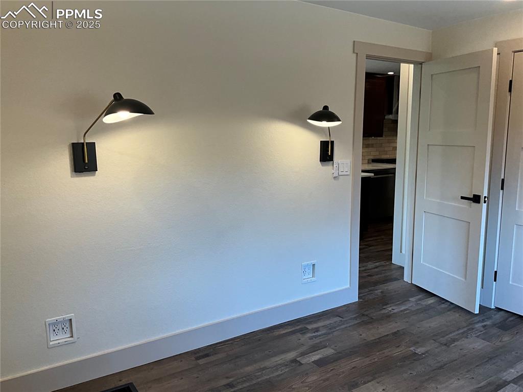 Image 18 of 50: Unfurnished room with dark wood-style flooring