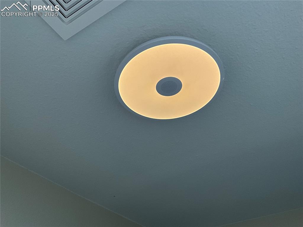 Image 33 of 50: Full bath with a Bluetooth light and speaker