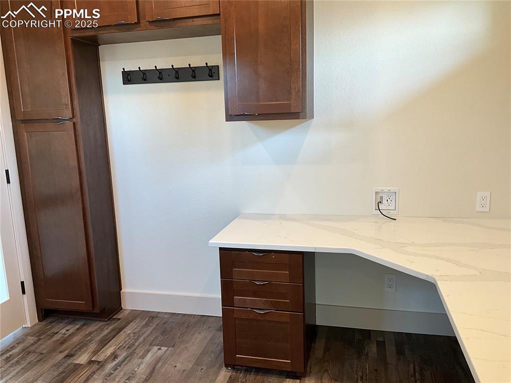 Image 36 of 50: Unfurnished office featuring built in desk and Marble Countertop