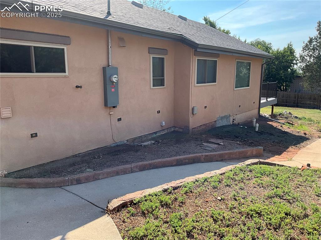Image 4 of 50: View of side of home featuring stucco siding, newer roof and updated electr