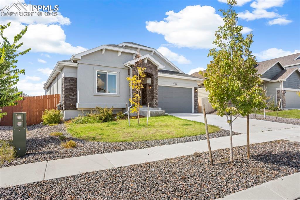 Image 11 of 41: Craftsman-style house featuring concrete driveway, stucco siding, a garage,