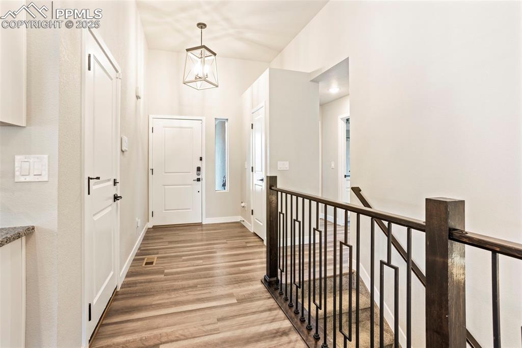 Image 13 of 41: Entryway featuring light wood-style flooring and a chandelier
