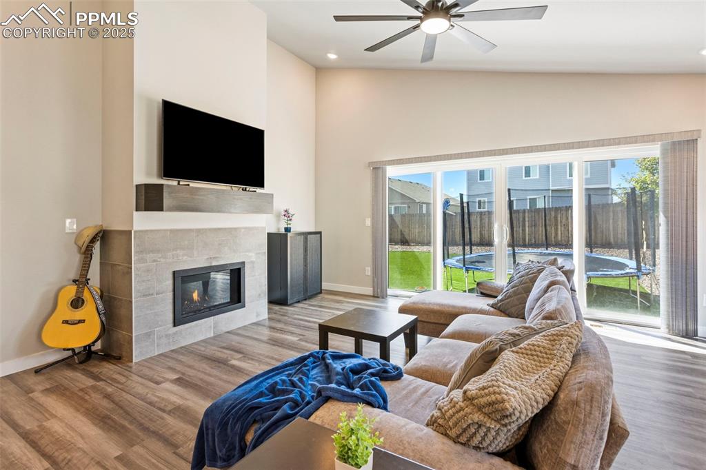 Image 14 of 41: Living area featuring plenty of natural light, a tile fireplace, wood finis