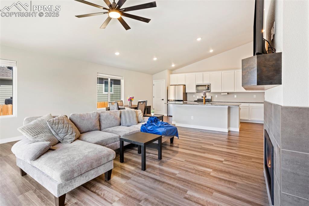 Image 16 of 41: Living room with recessed lighting, lofted ceiling, light wood finished flo