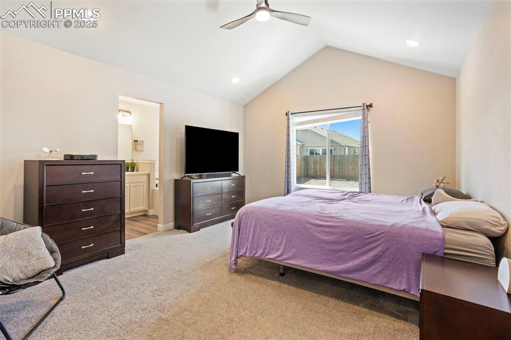 Image 21 of 41: Bedroom featuring light carpet, vaulted ceiling, recessed lighting, ceiling