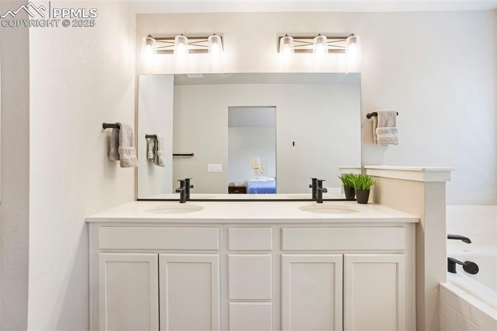 Image 23 of 41: Ensuite bathroom featuring double vanity and a garden tub