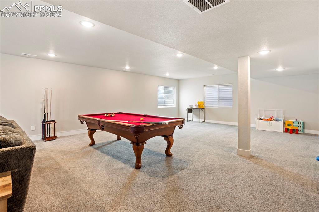 Image 31 of 41: Game room featuring light carpet, recessed lighting, pool table, and a text