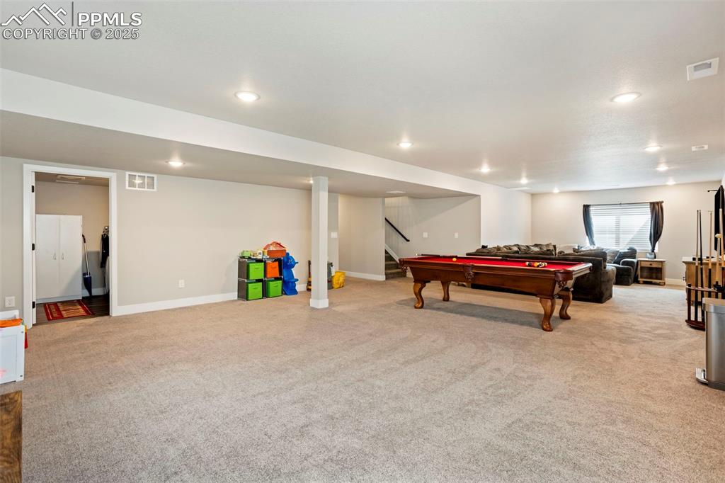 Image 32 of 41: Playroom with light carpet, recessed lighting, and billiards
