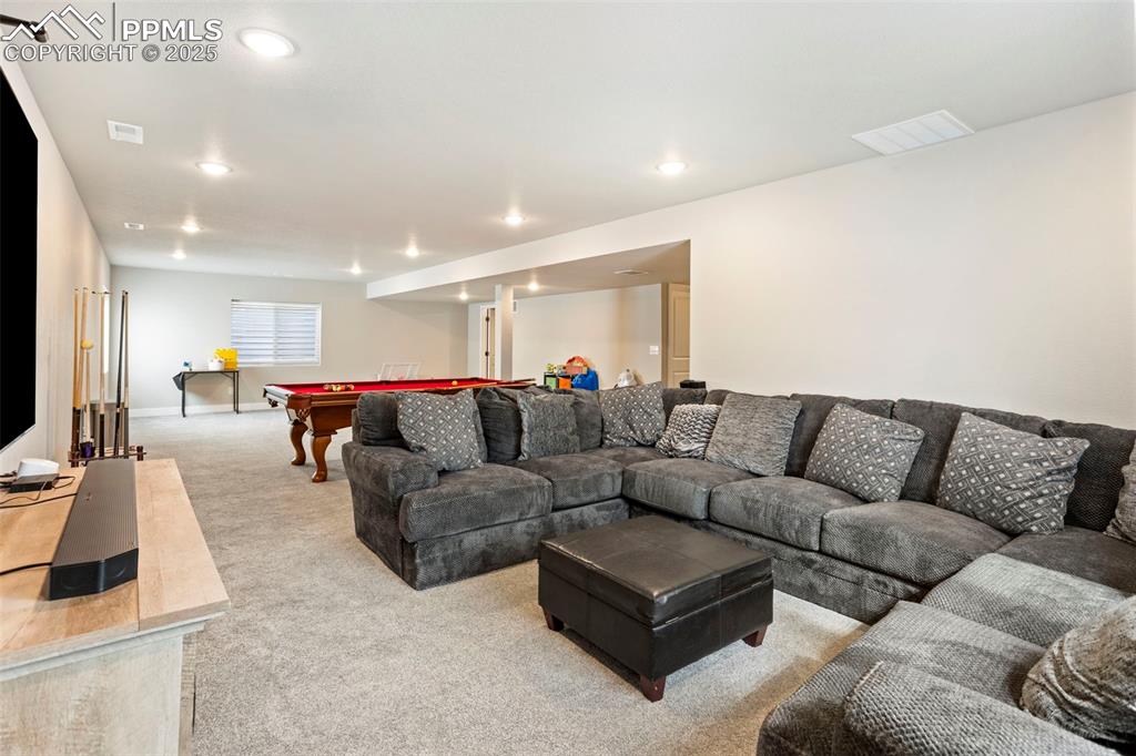 Image 34 of 41: Living area with pool table, carpet floors, and recessed lighting