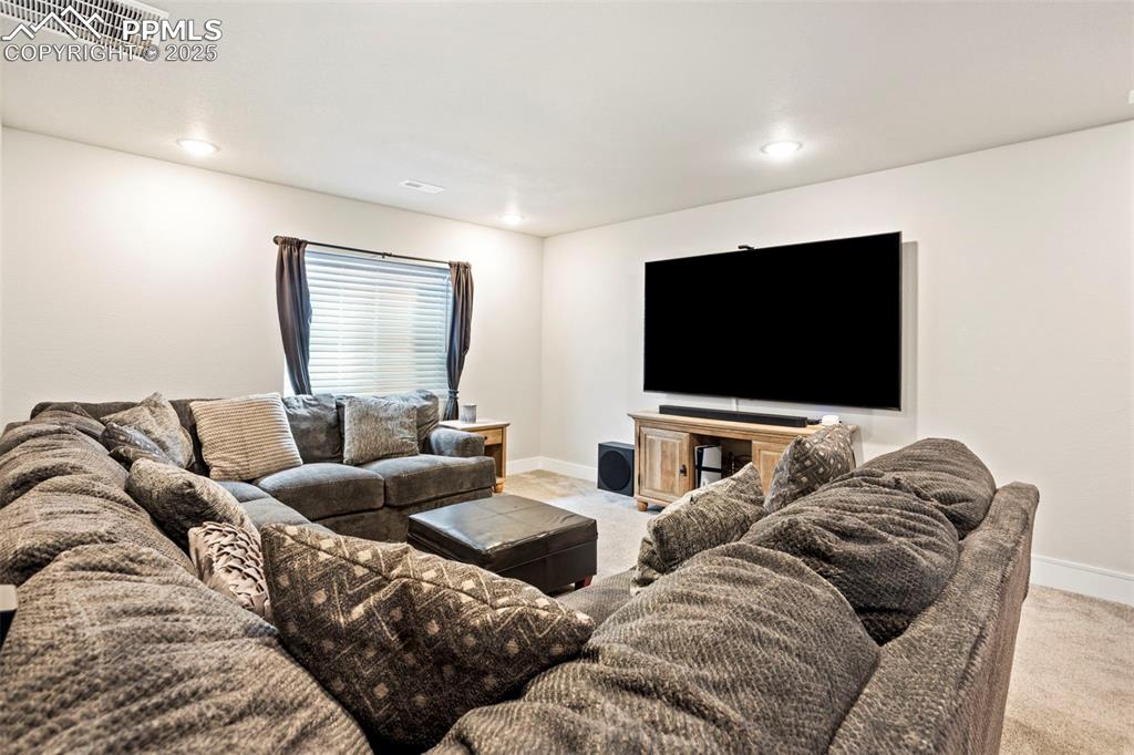 Image 35 of 41: Living room featuring light carpet and recessed lighting