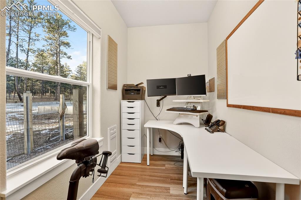 Image 13 of 50: Main level office with large window makes it a pleasure to work from home.