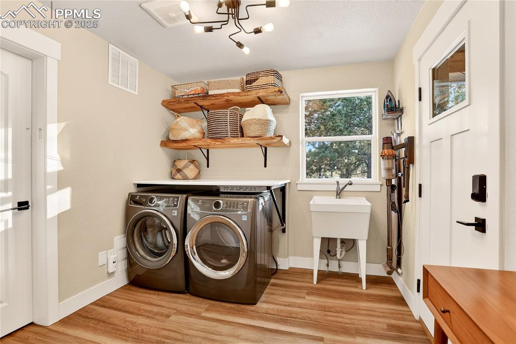 Image 14 of 50: Spacious laundry walks out to the covered patio