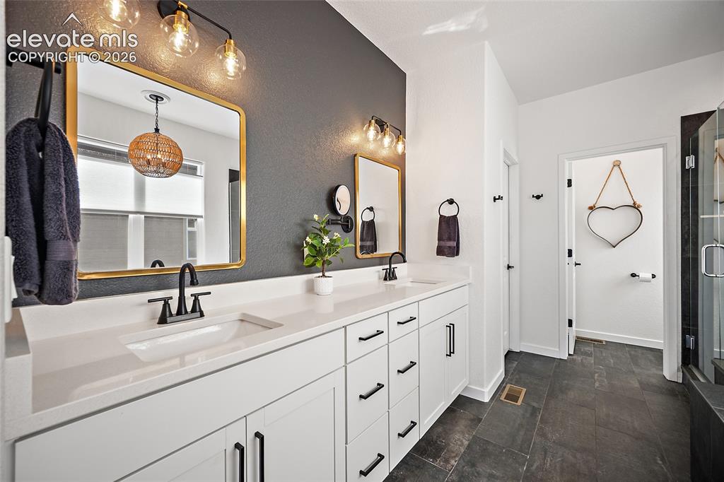 Image 20 of 46: Double vanity featuring white cabinetry with black hardware, white countert