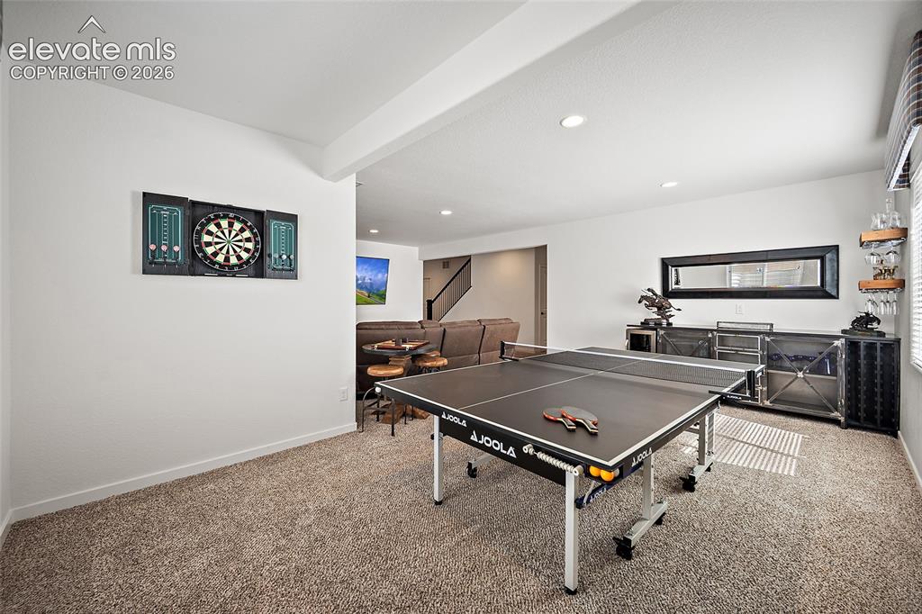 Image 30 of 46: Finished lower level featuring recessed lighting, plush carpeting, and a bu