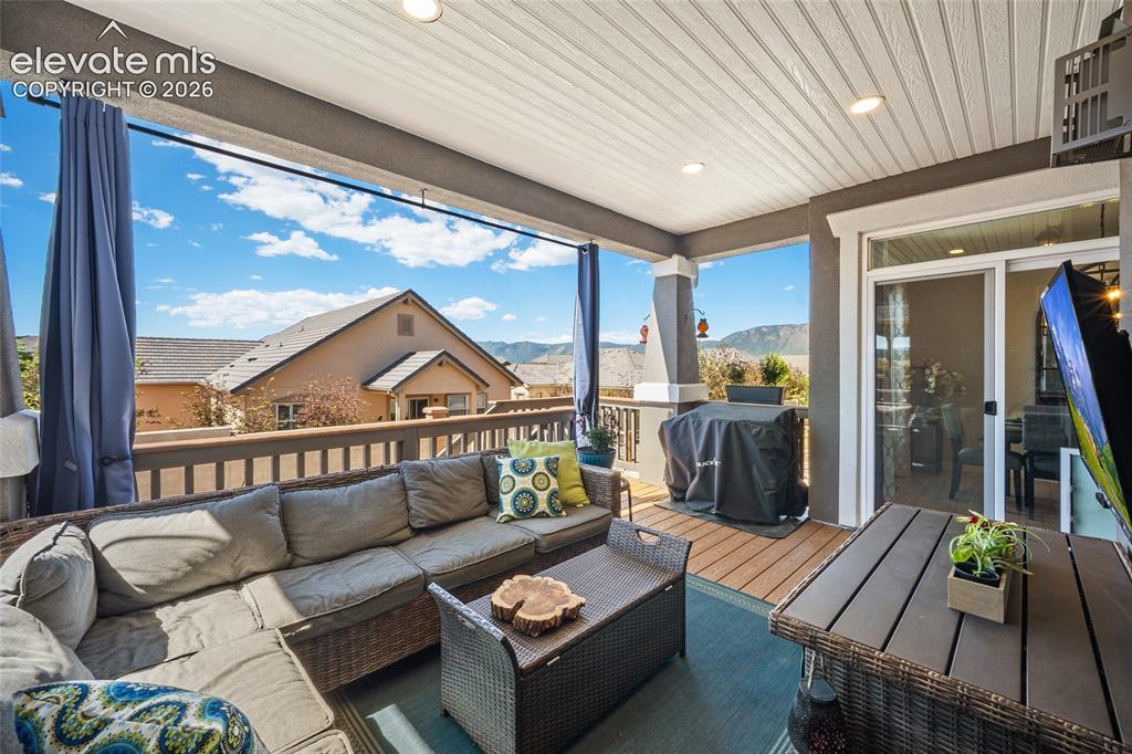 Image 37 of 46: Covered outdoor patio featuring a slatted ceiling with recessed lighting, d