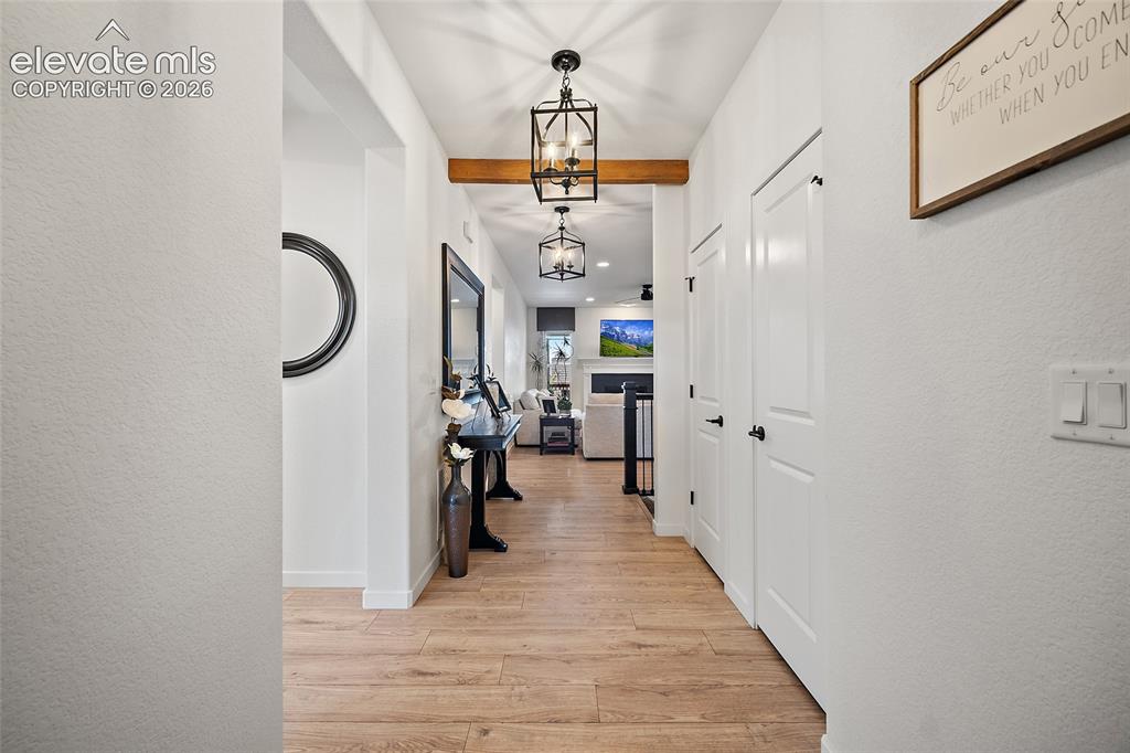Image 4 of 46: Hallway featuring wood-finish flooring, recessed lighting, and a decorative