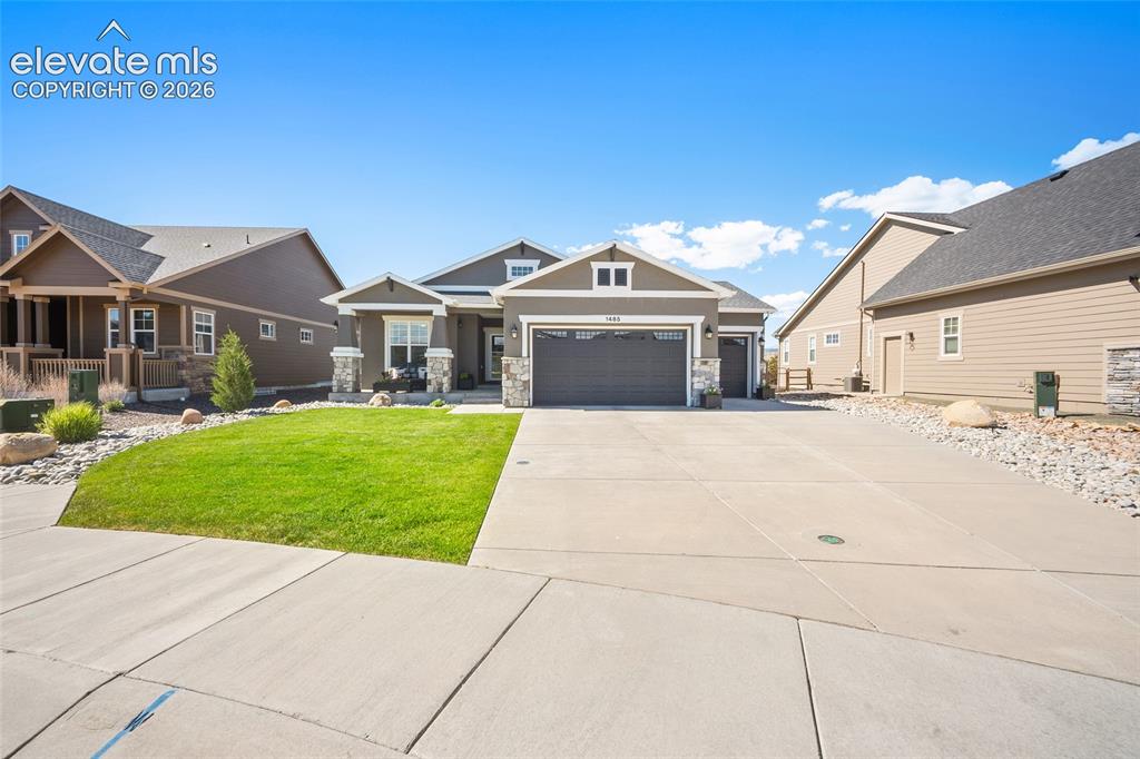 Image 42 of 46: Contemporary ranch-style home featuring a stone and siding exterior, an att
